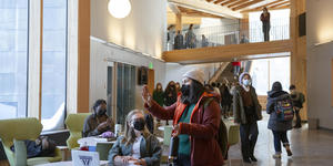 Professors from Wellesley College and University of Kansas Team Up to Study Social Impact of Face Masks Two students wearing face masks talk to each other in Wellesley's new Science Complex.
