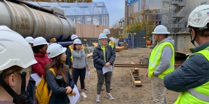 When a Construction Site Becomes the Classroom Students stand outside the science building wearing construction hats