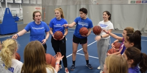 PERA Hosts Youth Sports Clinic to Celebrate National Girls and Women in Sports Day A group of student athletes lead a clinic with young girls.