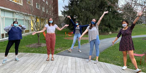 A Senior’s Experience as a Contact Tracer Inspires Her to Help Build Community on Campus people wearing masks and posing with their hands up in the air