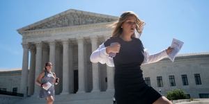 As Supreme Court Term Ends, Two Wellesley Professors Discuss Recent and Future Cases Two aids sprint down the steps of the Supreme Court holding decisions.