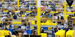 How the Rise in Online Shopping Affects the Planet workers in an Amazon shipping warehouse