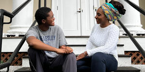 Black Excellence, In Their Own Words: The HistoryMakers Archive Is Now Available at Wellesley Izzy Torkornoo ’23 and Liseli Fitzpatrick speak to each other while sitting on the stairs of Harambee House.