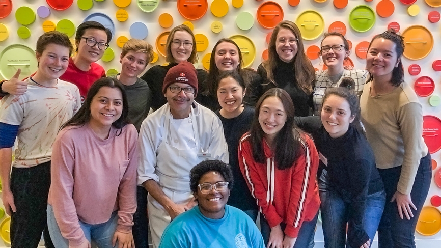 a group of students stand smiling together
