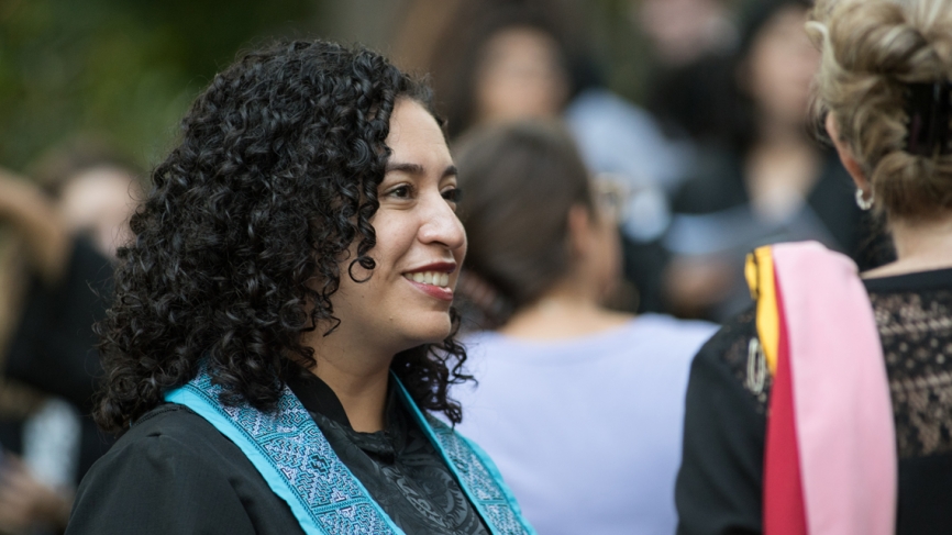 A side profile of a woman wearing graduation robes.