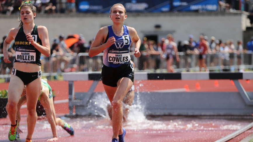 A Wellesley student runs on a track.