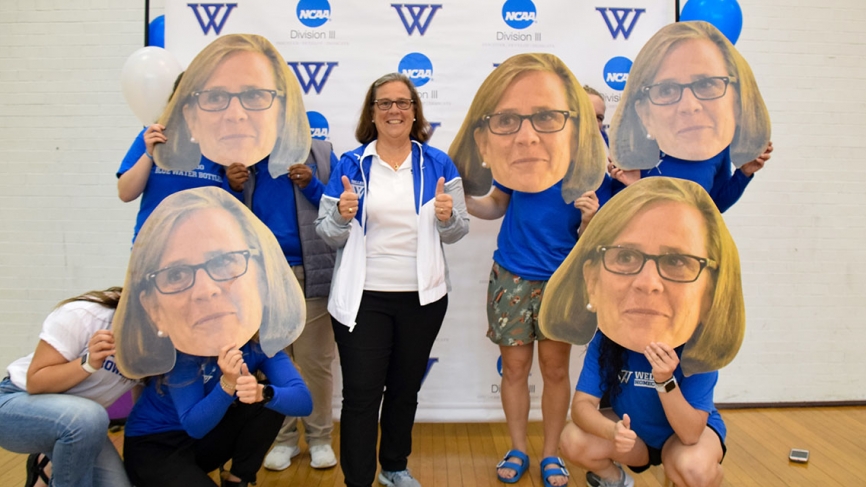 Bridget stands with a half dozen individuals who hold large cutouts of her face in front of their own
