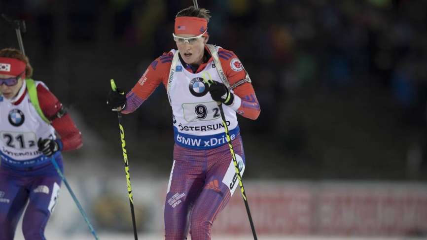 Clare Egan skis at a biathlon event