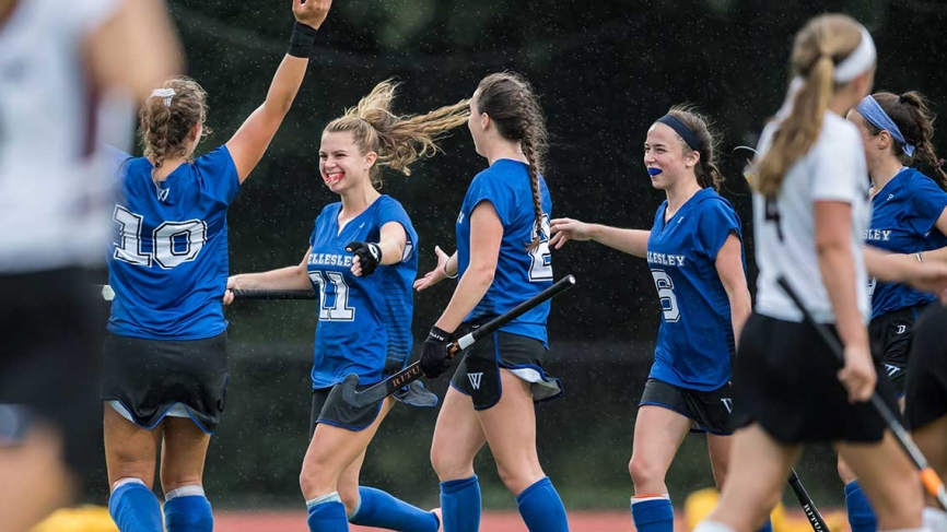 Field hockey team congratulate each other