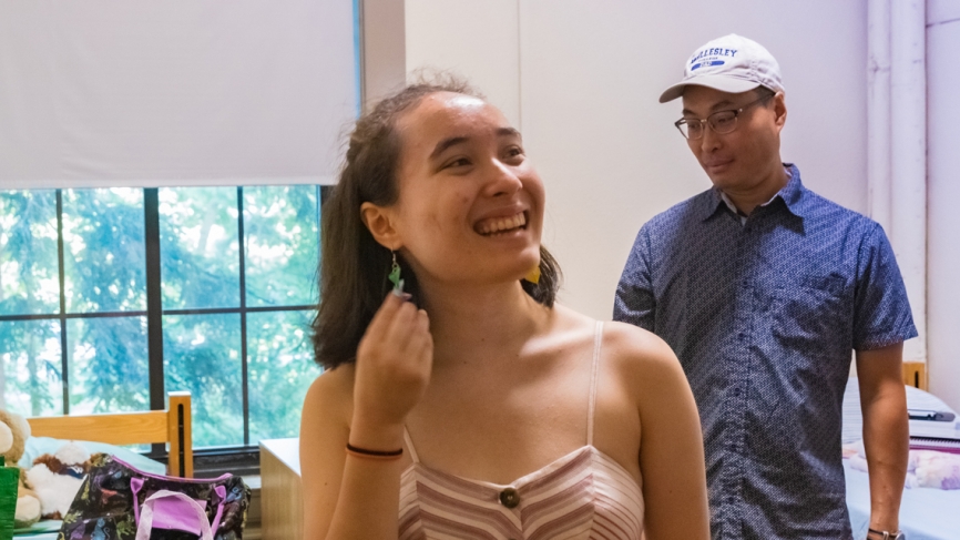 a student shows off her earring collection