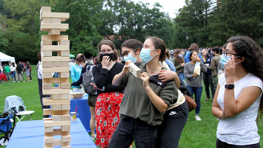 students playing with a giant jenga