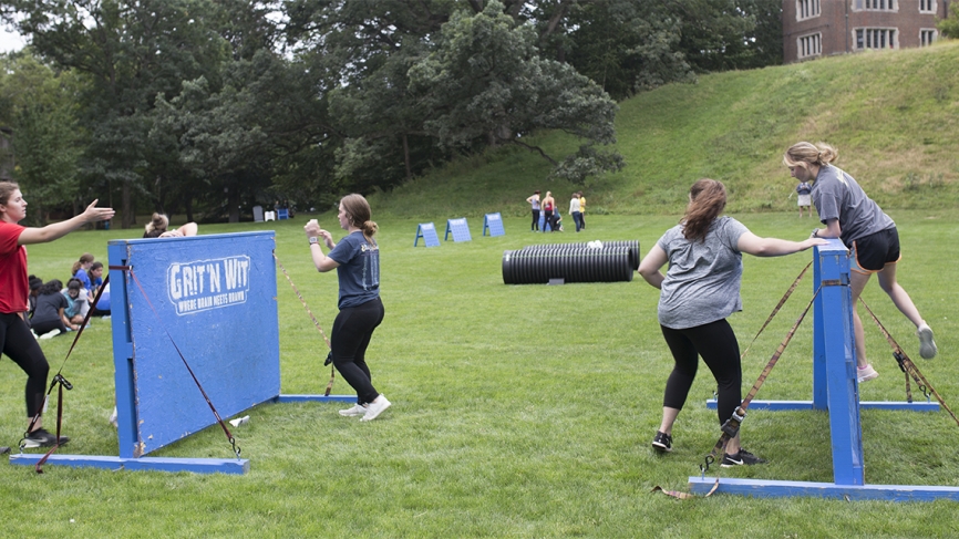 Students jump over obstacles on Severance Green.