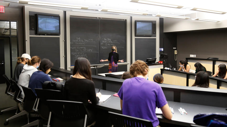 a person teaching a class wearing a mask