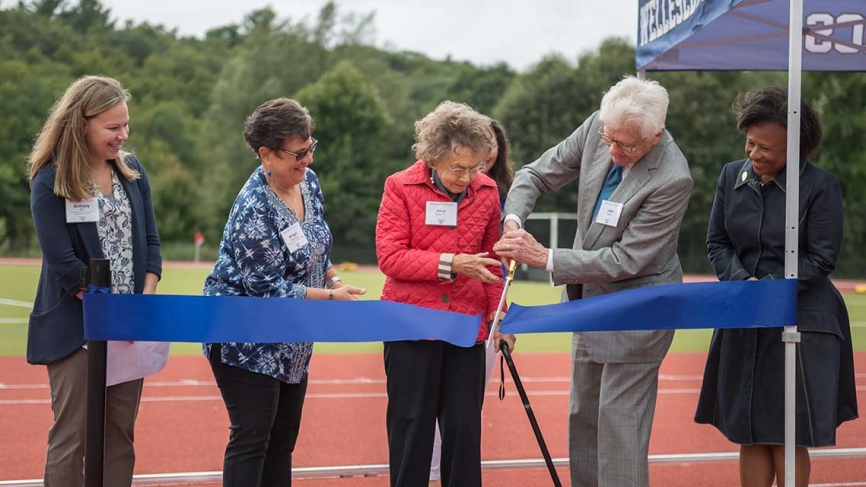 Donors cut a ceremonial ribbon before a game.