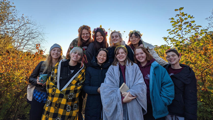 A group of students gather outside at dawn