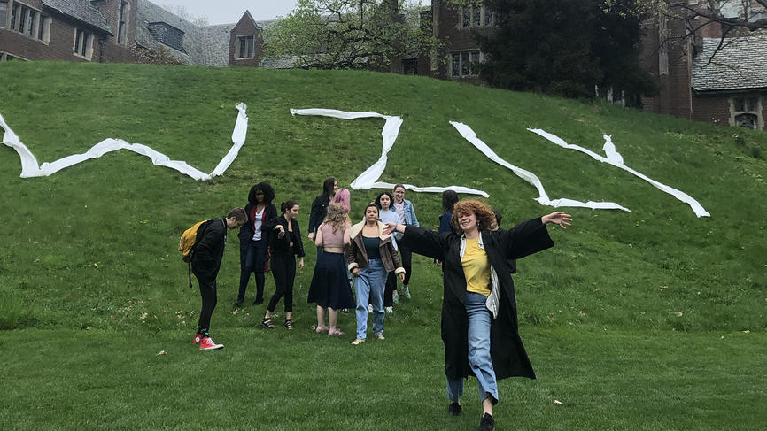 Students stand in front of the green where WZLY is spelled out in toilet paper.