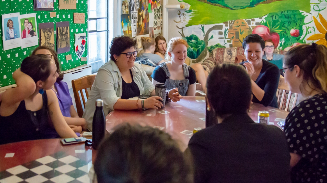 Ray Acheson sits with students at El Table