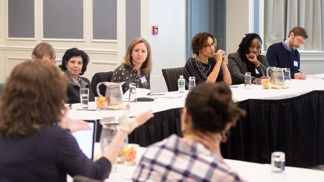 Faculty and staff sit at tables discussing diversity and inclusion at Wellesley