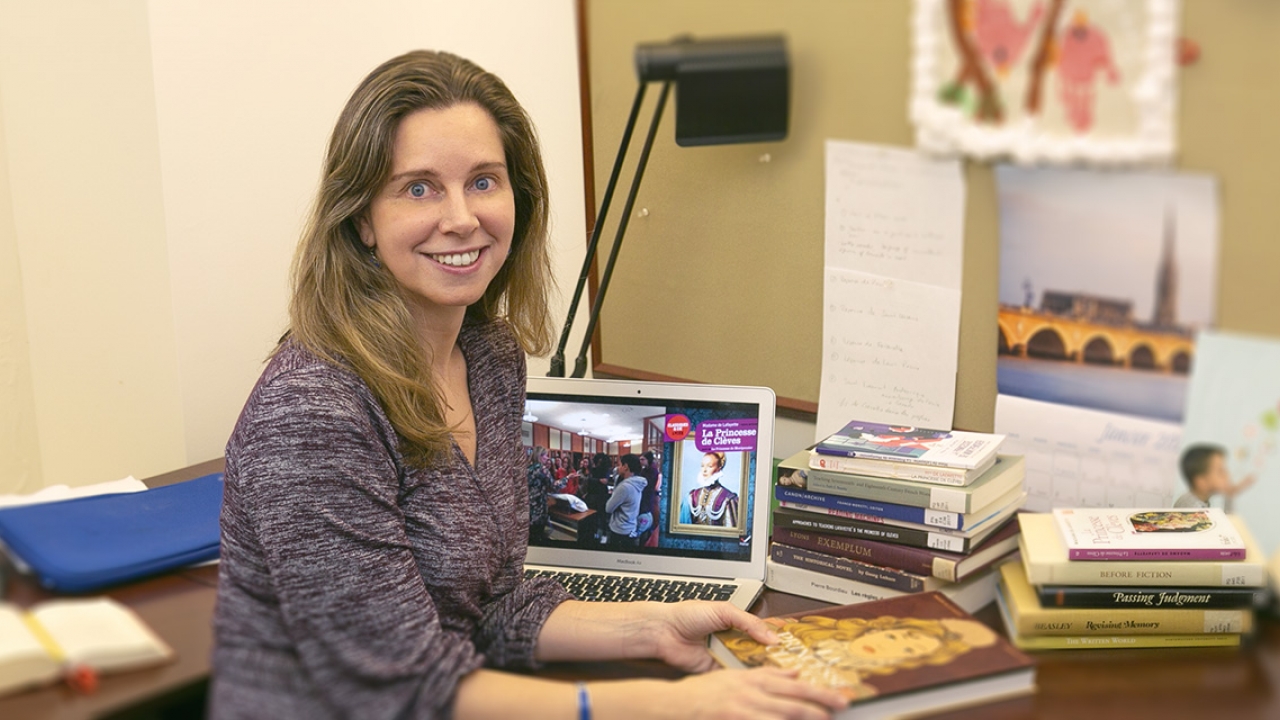 Helene Bilis sits at her desk in the Newhouse Center