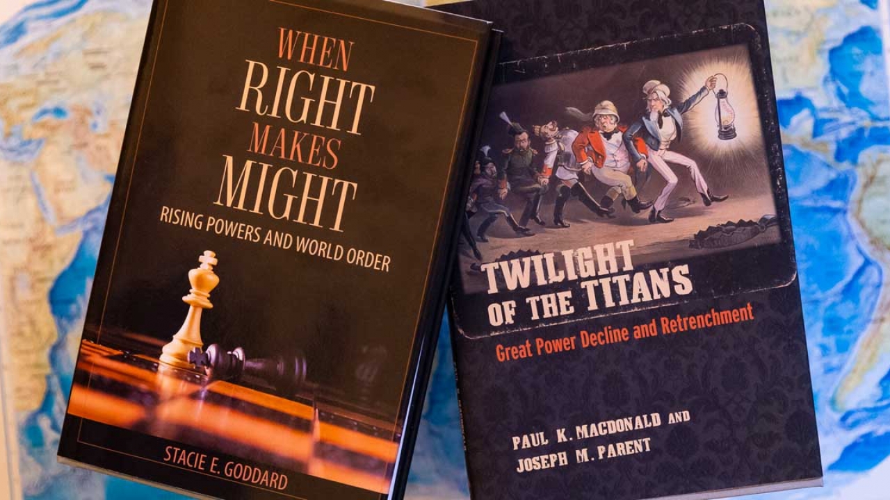 Two books appear on a map of the world. They read: When right makes might and twilight of the titans.