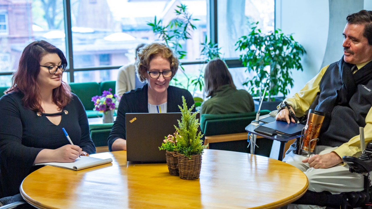 Members of the accessibility and disability resources team sit around a table.