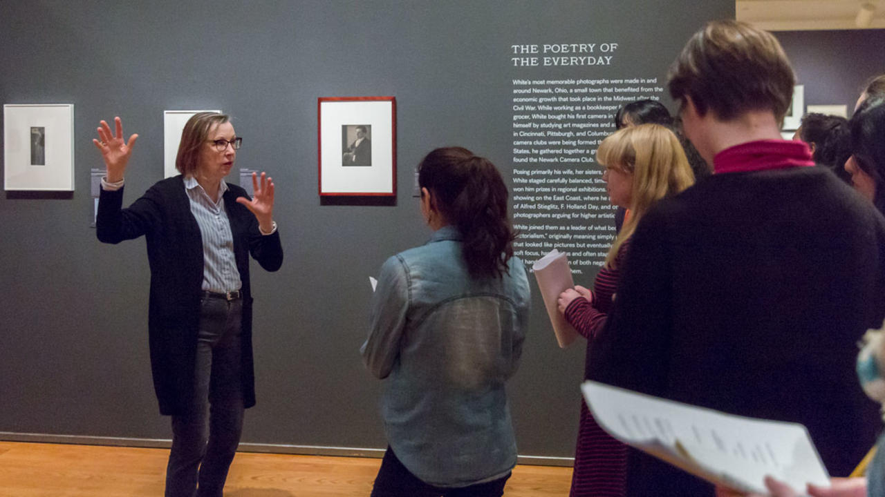 Student guides look at exhibitions in the Davis Museum. 