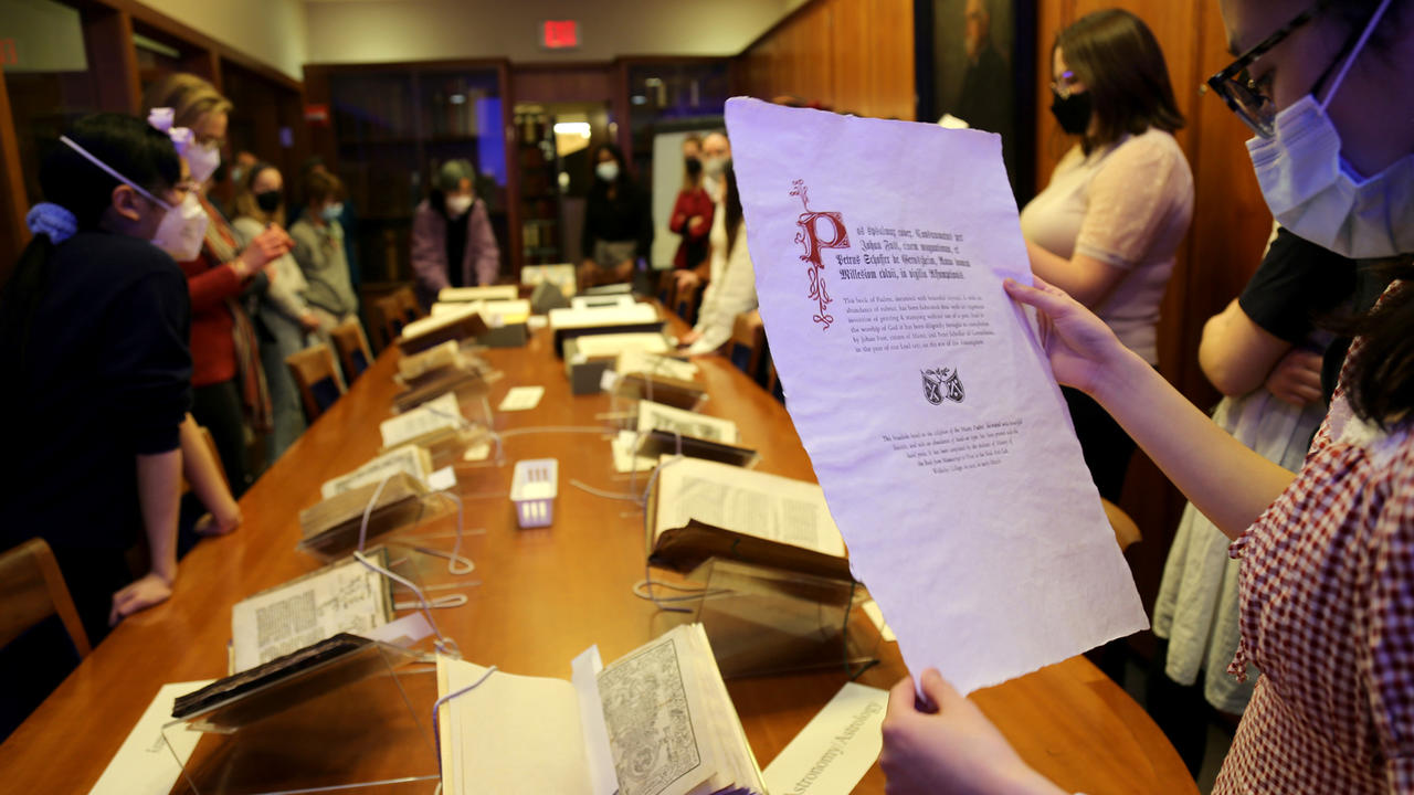 A student looks at a manuscript page