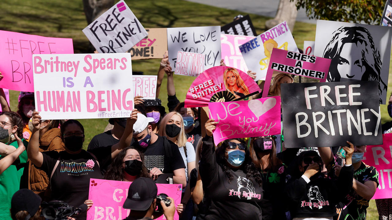 Britney Spears fans hold signs outside a Los Angeles court hearing concerning the pop singer’s conservatorship on March 17, 2021