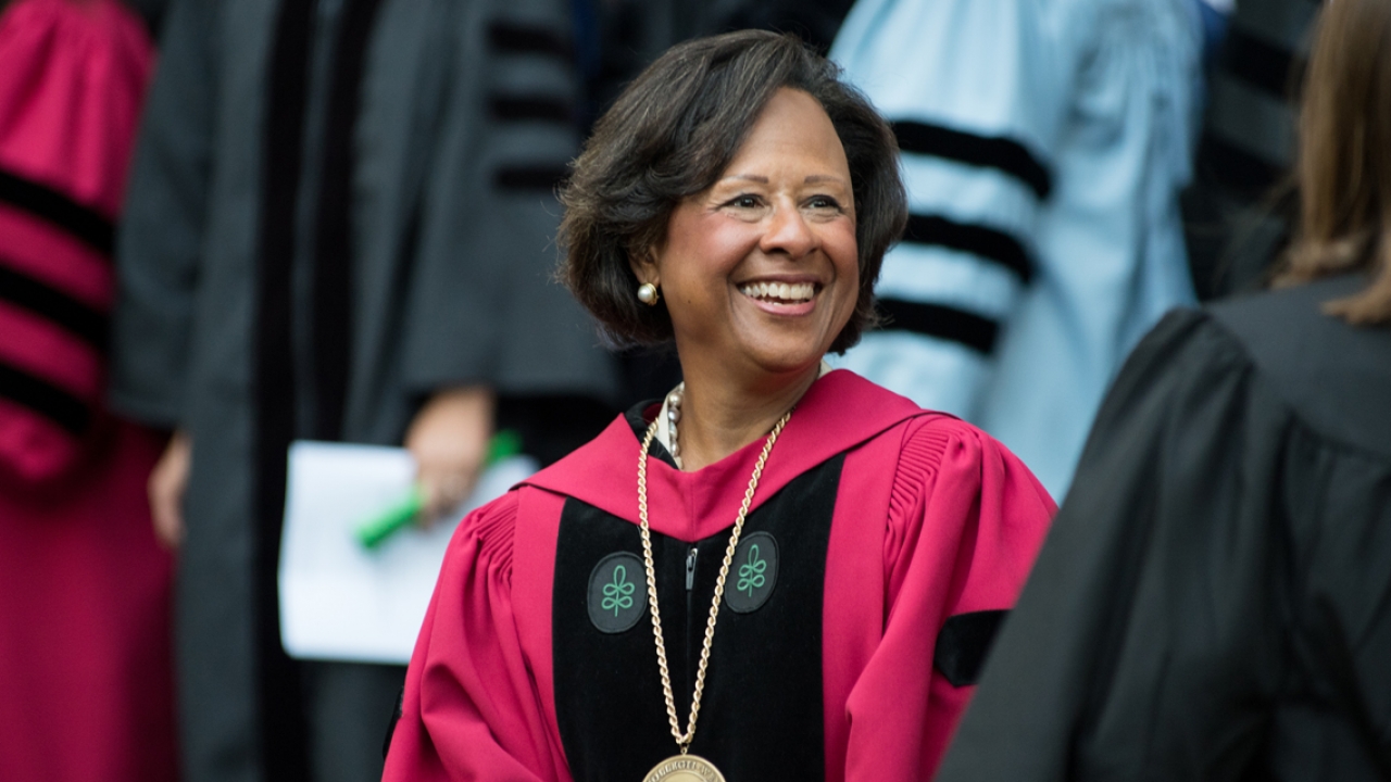 President Johnson smiles as students walk by her at convocation.