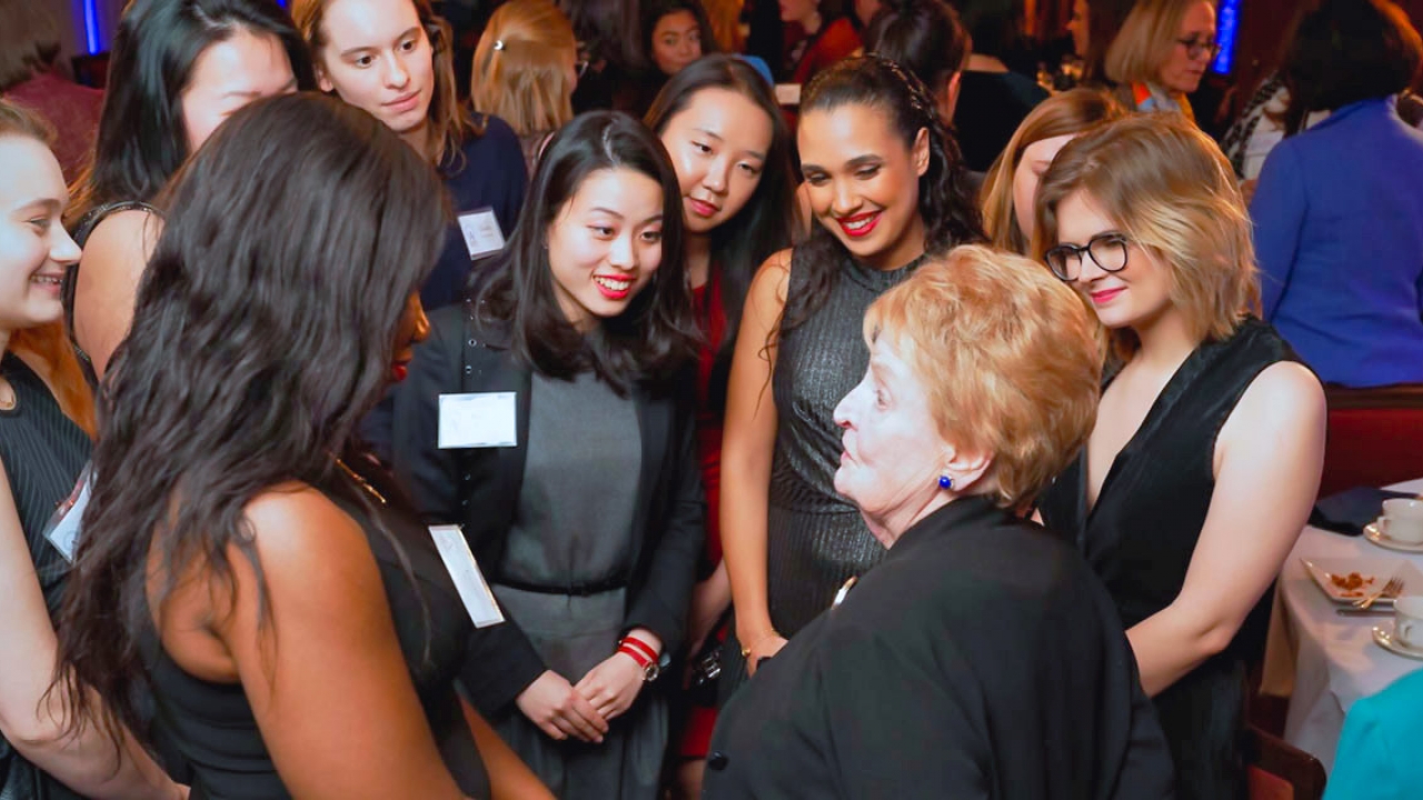 Madeleine K. Albright talking with students at an Albright Institute event.