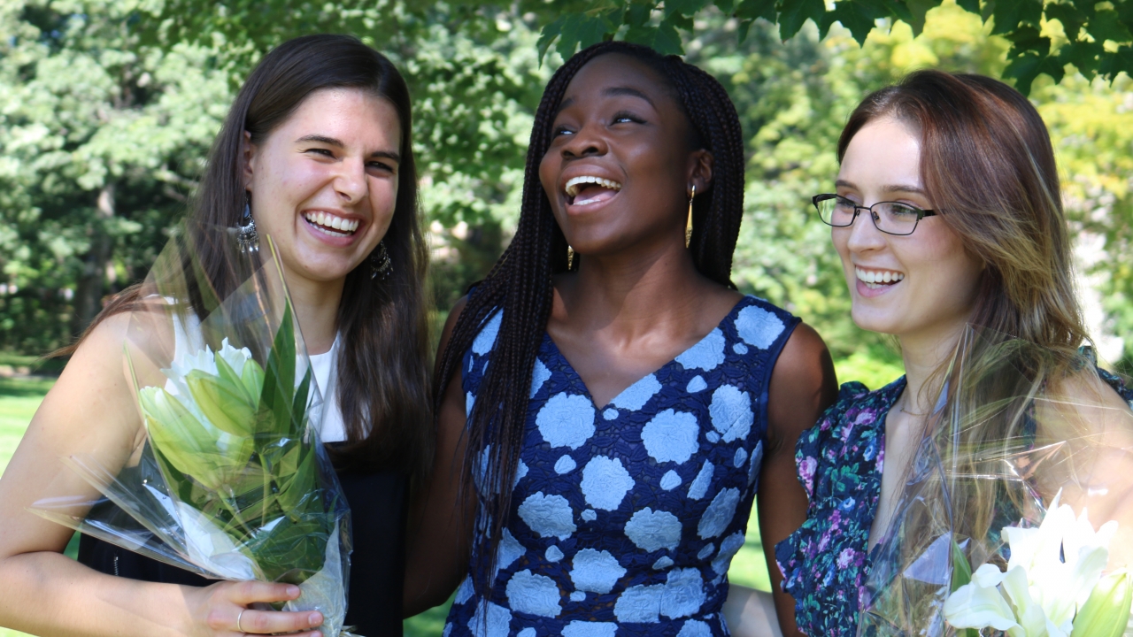 Three students laugh together on Flower Sunday.