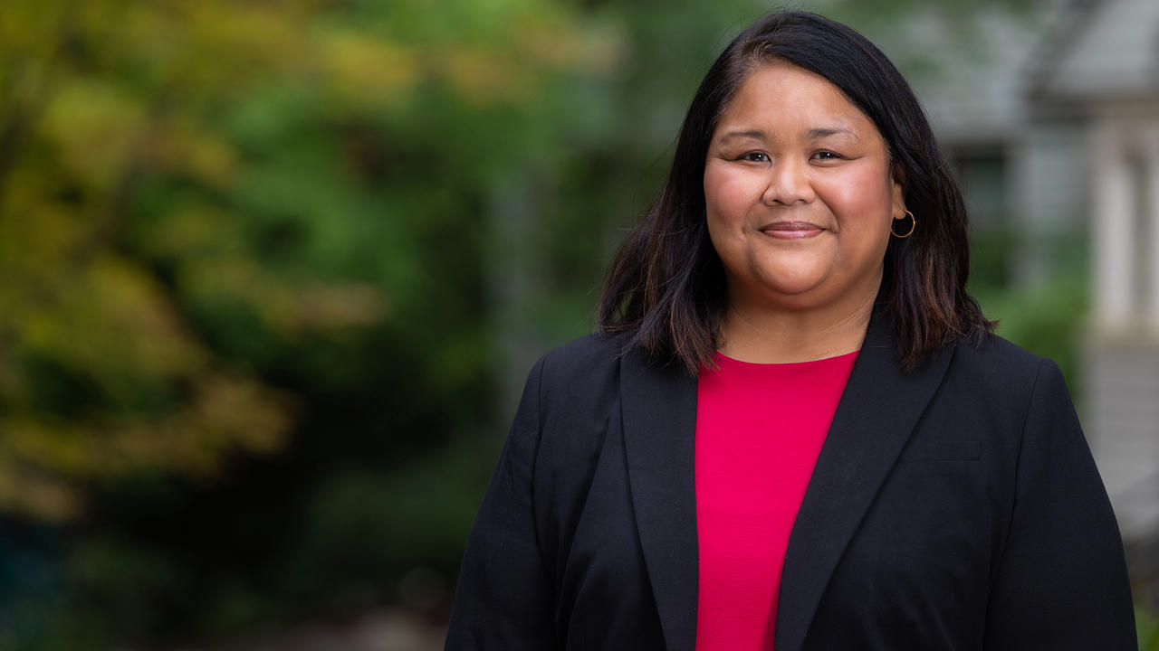 A portrait of Peaches Valdes. She wears pink top under a dark blazer.