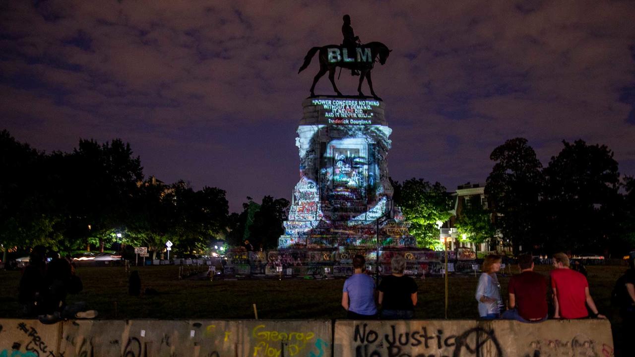 Frederick Douglass’ image is projected on the Robert E. Lee Monument