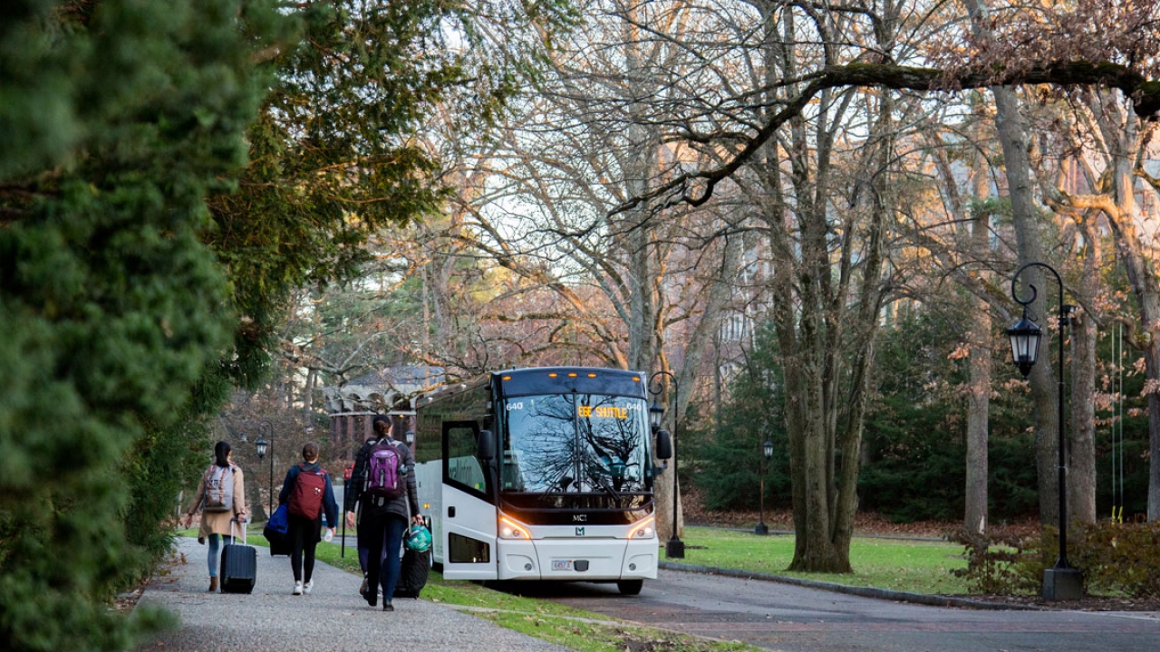 Students walk to a bus outside the chapel, bound for Boston.